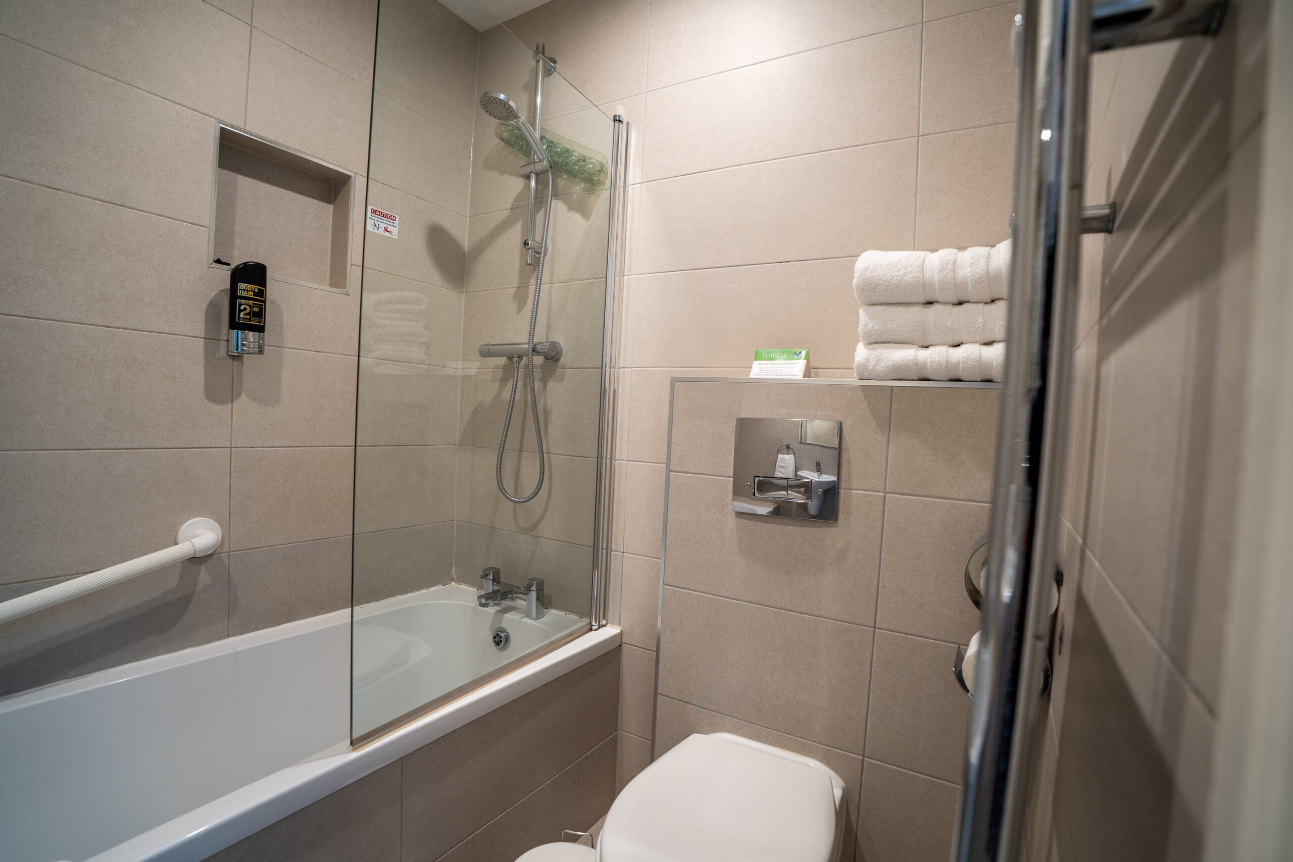 Modern en-suite bathroom at Clifden Guesthouse Dublin with shower, toilet, sink and fresh towels